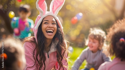 Woman in a bunny costume, sharing laughter and happiness with a group of children during an Easter egg hunt