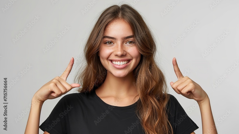 Portrait of an American woman in black t shirt indicating  two forefingers up in a clean backdrop with copy space, Generative AI. - obrazy, fototapety, plakaty 