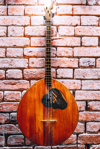 Musical instrument domra on brick wall background © ArtEvent ET