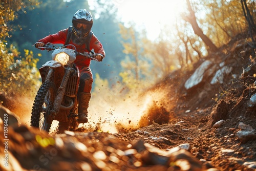 Motocross rider on the race on the track in the forest. Motocross. Enduro. Extreme sport concept. © John Martin