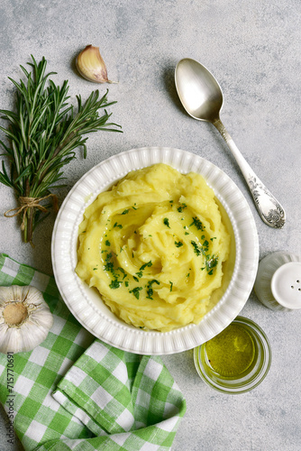 Mashed potato in mediterranean style with rosemary, parmesan cheese, garlic and olive oil. Top view with copy space.