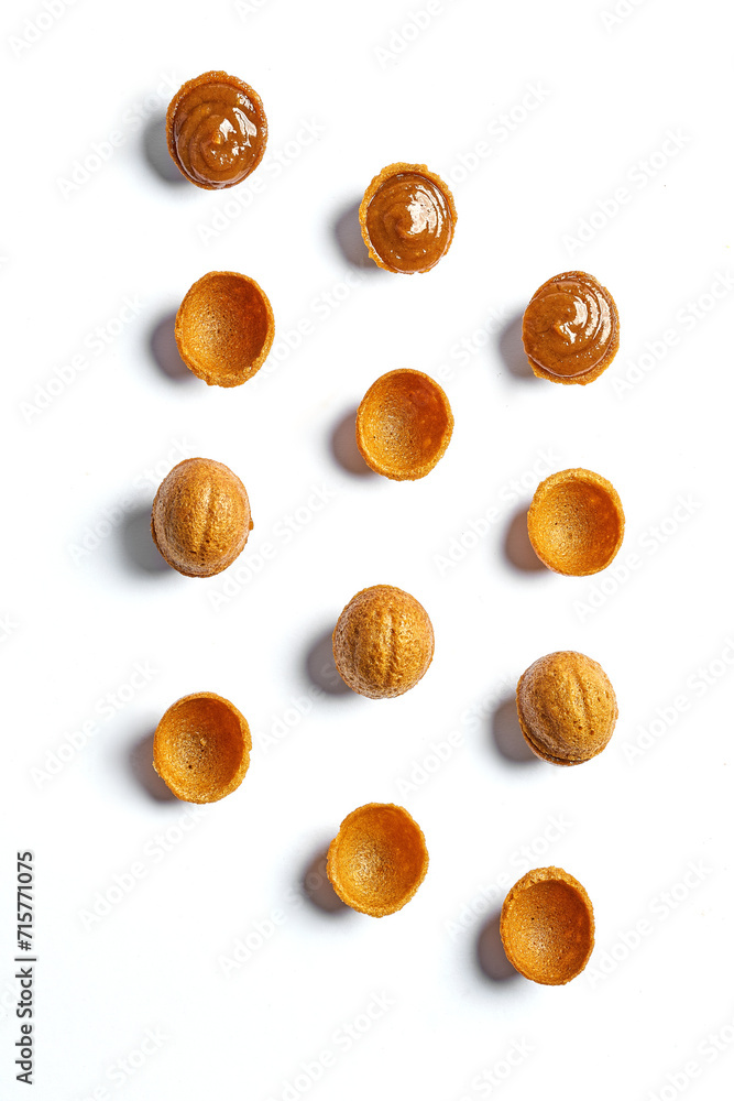 Nuts with condensed milk or caramel. Pattern on a white background. Minimalism Nuts with condensed milk or caramel. Pattern on a white background. Minimalism