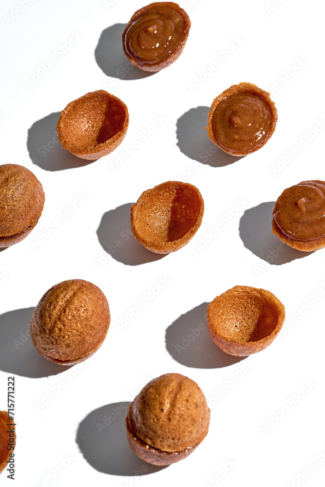 Nuts with condensed milk or caramel. Pattern on a white background. Minimalism Nuts with condensed milk or caramel. Pattern on a white background. Minimalism