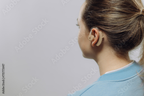 man with a hearing aid on a white background in a shirt without a face