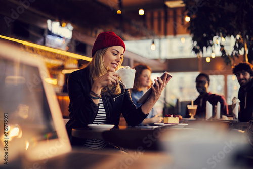 Young woman using tablet in cafe