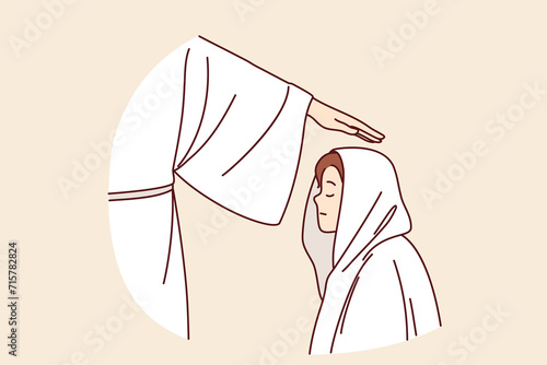 Religious ritual with initiation boy into brotherhood, and hand of apostle in white robe above child head. Religious ceremony with sect member during pronunciation of oath or baptism of teenage kid