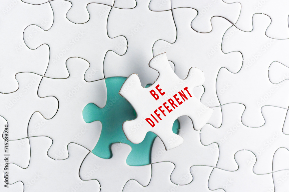 Be different text on Jigsaw Puzzle over green background. Be different text on Jigsaw Puzzle over green background.