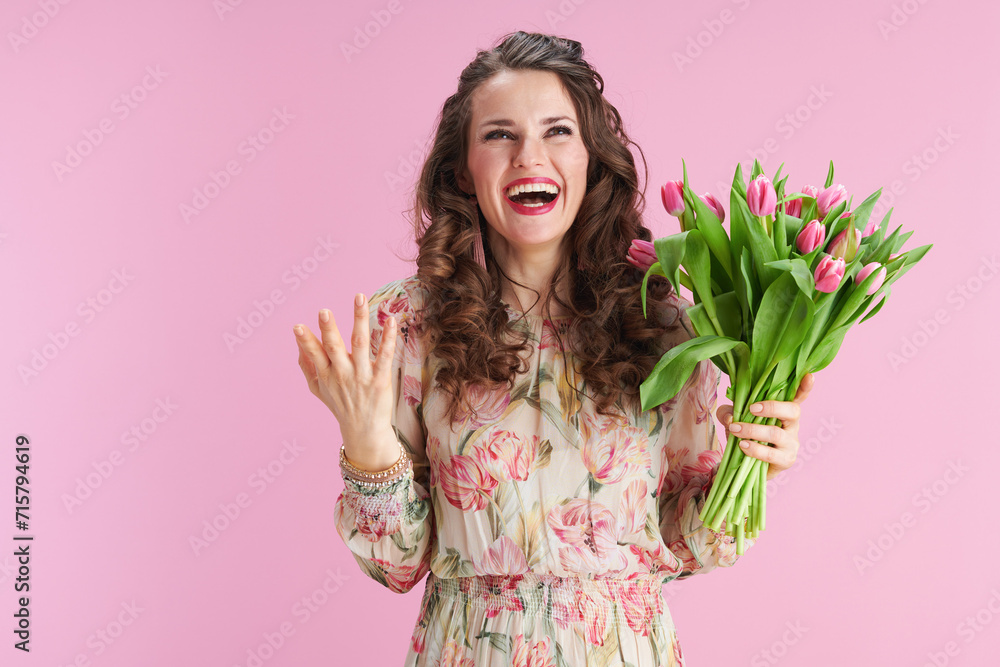 smiling young woman with long wavy brunette hair on pink smiling young woman with long wavy brunette hair on pink