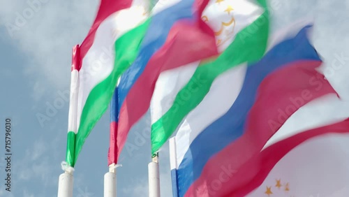 Close-up of Russian and Tajikistani flags. The flags are waving in the wind. 4K. photo