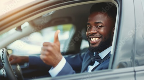 African American businessman showing thumb up while on expensive ca, New car, Car insurance concept. © Oulaphone
