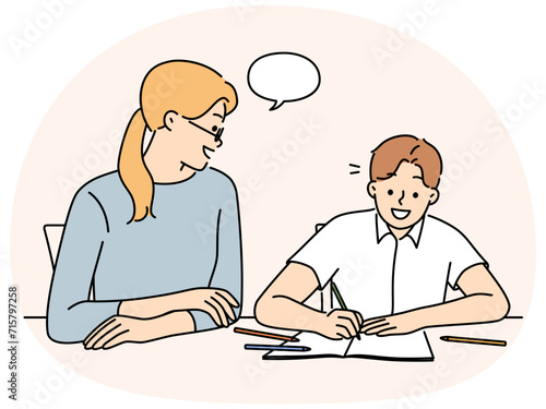 Mother do homework with smiling son