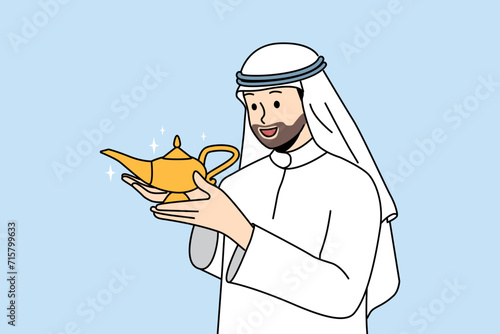 Arab man with aladdin lamp in hands makes wish, wanting to call genie or wizard to help. Guy in islamic clothing holds golden antique jug, similar to vessel from fairy tale about aladdin
