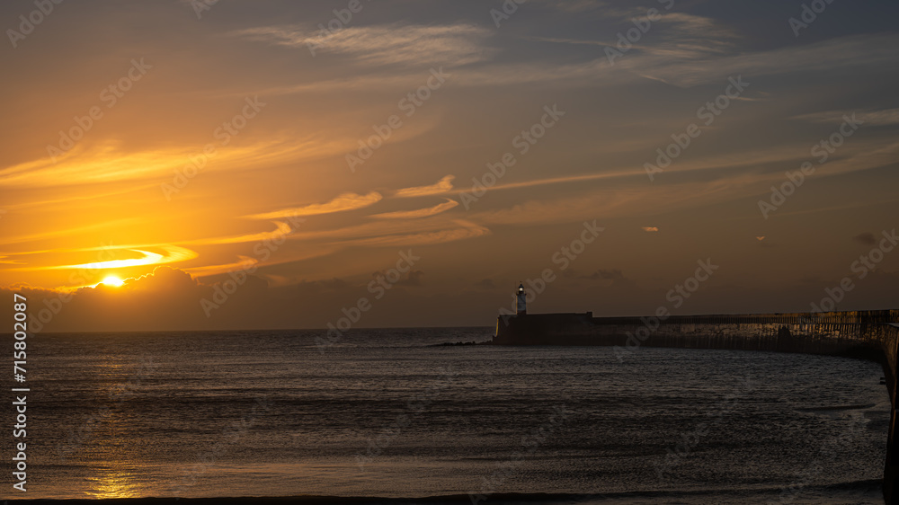 Newhaven Harbour with lighthouse at sunrise 
