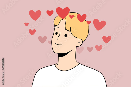 Man in love feels sympathy for girlfriend and smiles, fantasizing about future date or wedding. Guy is in romantic mood after going on date with girl or receiving congratulations on valentine day