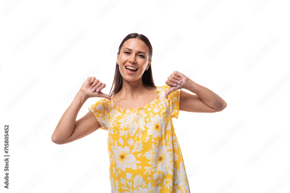 young pretty woman with straight black hair in a yellow sundress with a daisy pattern young pretty woman with straight black hair in a yellow sundress with a daisy pattern
