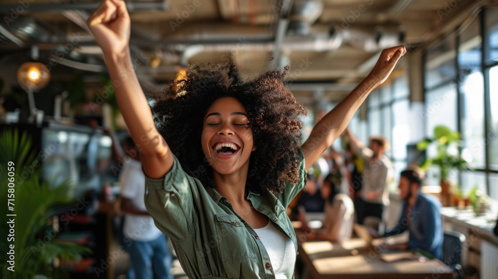 Group of people are celebrating in an office environment, with one woman in the center laughing and raising her arms in joy, surrounded by her colleagues who are also expressing happiness. - obrazy, fototapety, plakaty 