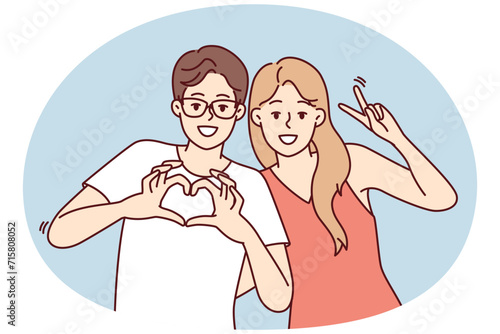 Friendly young man and woman stand in embrace and smiling looking at camera. Guy and girl in casual clothes show different gestures while posing for friendly photo. Flat vector illustration