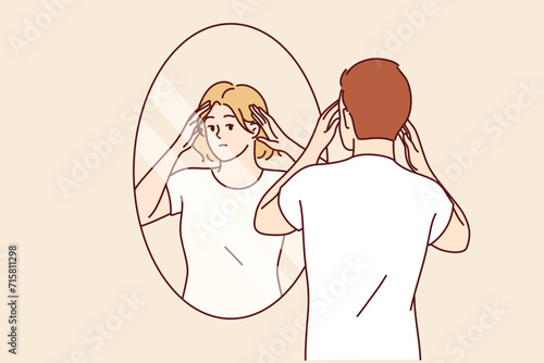 Man identifies himself as woman by looking in mirror and seeing girl in reflection, for concept of tolerance for LGBTq. Gender identification of person causing censure due to lack of tolerance