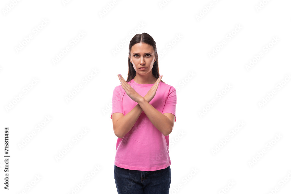 young stylish woman with straight black hair dressed in a pink t-shirt crossed her arms young stylish woman with straight black hair dressed in a pink t-shirt crossed her arms
