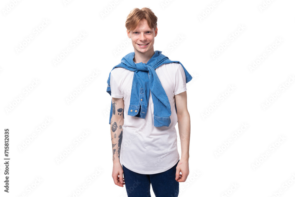 young charming slender red-haired man with a short haircut with a tattoo on his arms is dressed in a stylish blue shirt young charming slender red-haired man with a short haircut with a tattoo on his arms is dressed in a stylish blue shirt