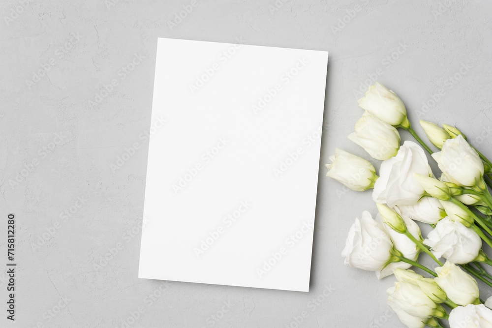 Wedding invitation card mockup with white flowers, top view with copy space Wedding invitation card mockup with white flowers, top view with copy space