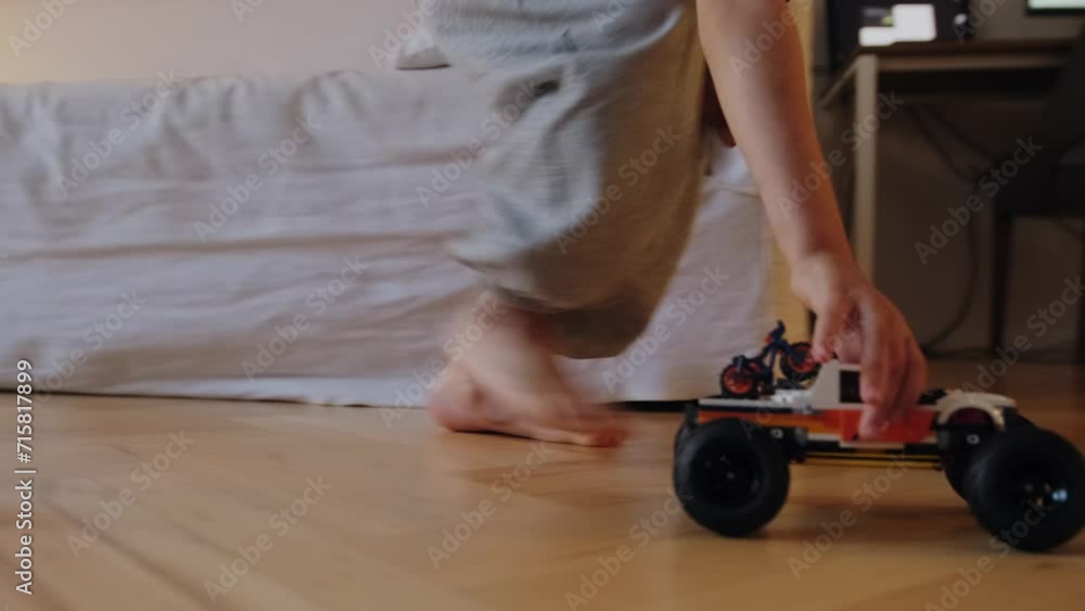 A boy plays with a car. A boy plays with a car.