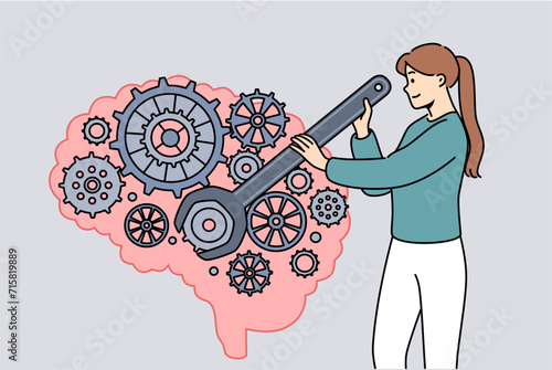 Woman is developing brain and improving intelligence by turning gears with wrench. Concept of neuro hacking and attempts to improve memory or create artificial intelligence for industrial purposes