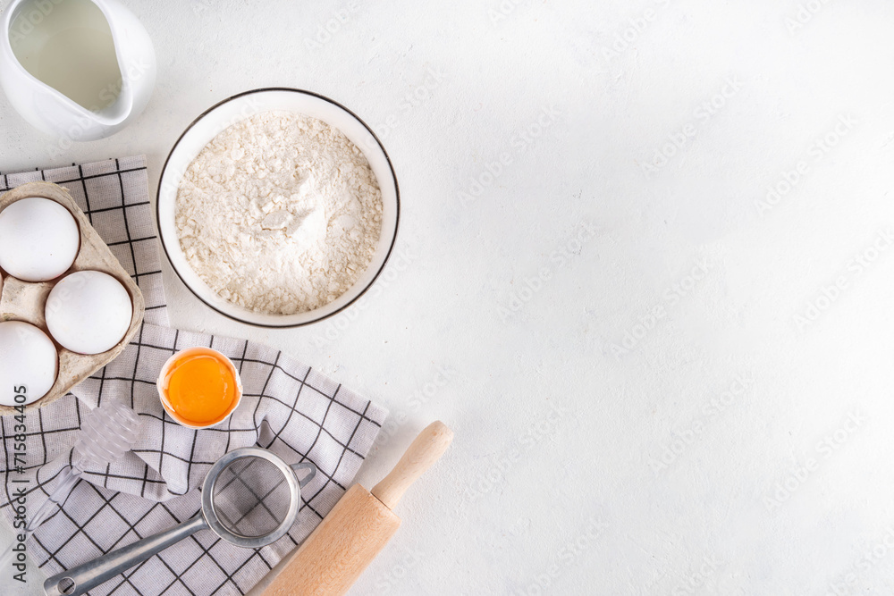 Empty space baking background with bakery ingredients - flour, milk, eggs, rolling pin. Simple pastry baking flat lay top view border Empty space baking background with bakery ingredients - flour, milk, eggs, rolling pin. Simple pastry baking flat lay top view border