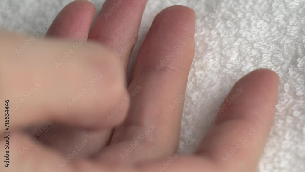 Close-up of hands on white bath towel. Details of a white terry towel. Close-up of hands on white bath towel. Details of a white terry towel.