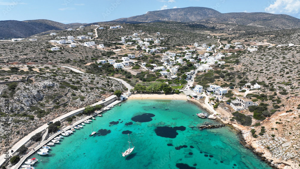 Fototapeta premium Aerial drone photo of paradise sandy beach of Agios Georgios with natural tree shade next to main port of Iraklia island, Small Cyclades islands, Greece