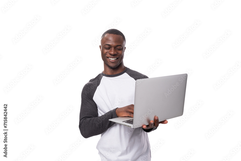 young american man dressed casually working using laptop young american man dressed casually working using laptop