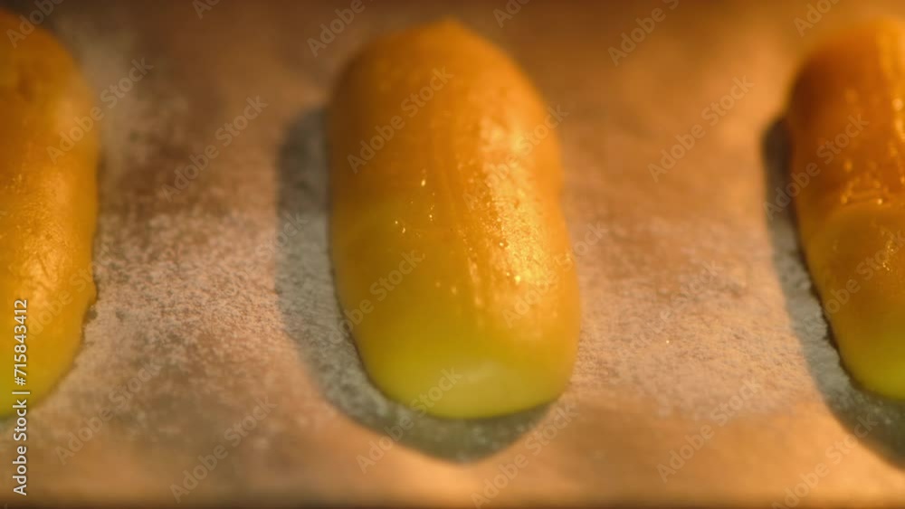The process of baking dough for eclairs in the oven in the home kitchen, time lapse The process of baking dough for eclairs in the oven in the home kitchen, time lapse