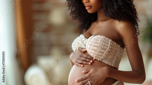 Pregnant woman hugging her belly closeup view photo