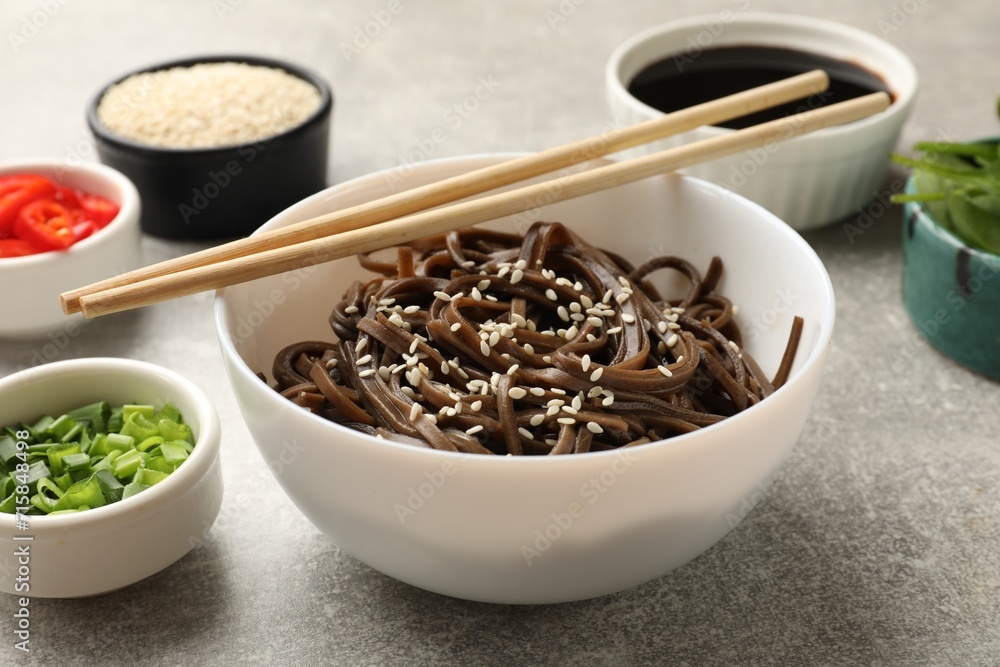 Tasty buckwheat noodles (soba) with sesame served on light grey table Tasty buckwheat noodles (soba) with sesame served on light grey table