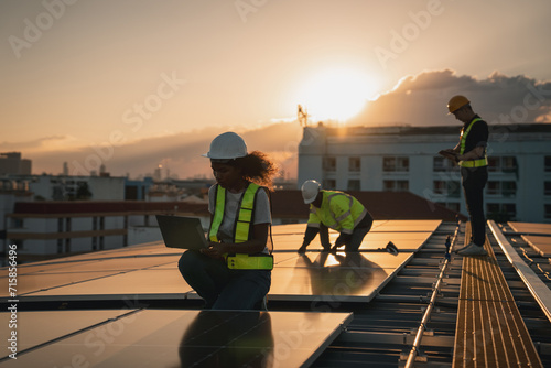 Service engineer checking solar cell on the roof for maintenance if there is a damaged part. Engineer worker install solar panel. Clean energy concept. photo
