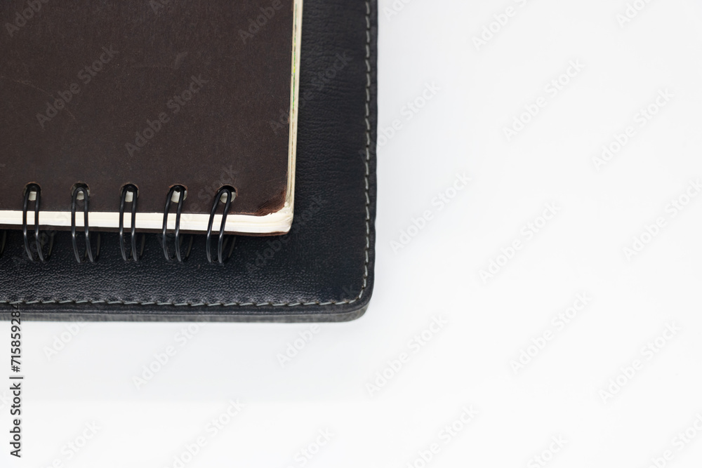 black notebook on white background with clipping path writing in spiral notepad on isolated., black notebook on white background with clipping path writing in spiral notepad on isolated.,