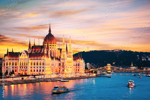 Incredible spectacular picturesque sity landscape of the Parliament and the famous Szechenyi chain bridge over the Danube in Budapest, Hungary at sunset. Charming places.