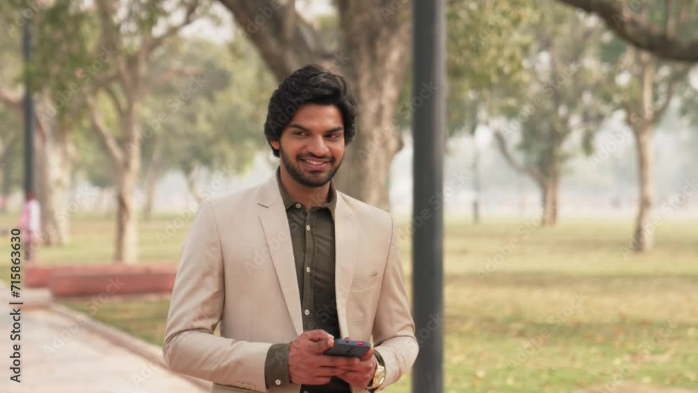 Successful Indian Businessman Walking While Texting Successful Indian Businessman Walking While Texting