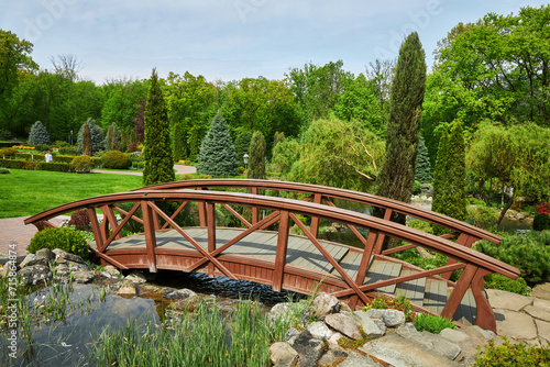 Wooden bridge in a park. Summer park with bridge.
