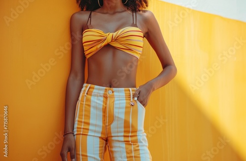 a woman wearing striped pants and a top