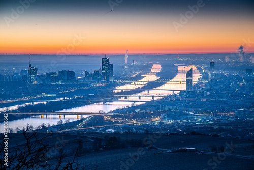 Aerial view on the capital city of Austria, Vienna with the two streams of the Danube river in the blue hour just before sunrise