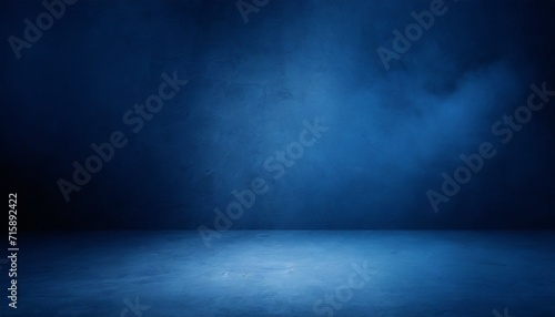 empty dark blue abstract cement wall and studio room with smoke float up the interior texture for display products wall background