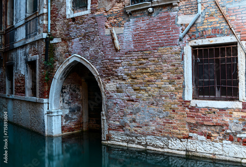 Venetian canal with gothic arch wall textures and windows