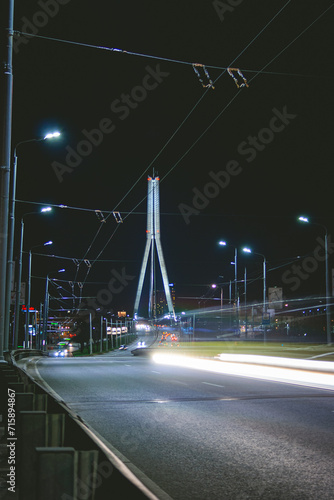 Vansu bridge in Riga, Latvia during night with traffic on it. Vansu bridge is a is a cable-stayed bridge that crosses the Daugava river. Night and street photography in urban setting. photo