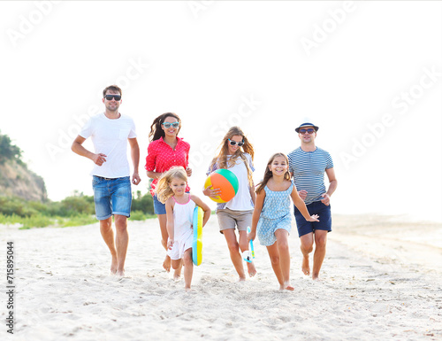 Group of young people with kids on the beech