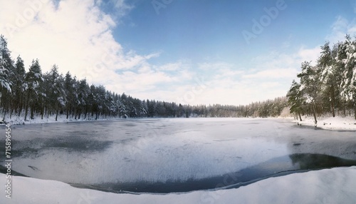 frozen lake and snow covered forest © William