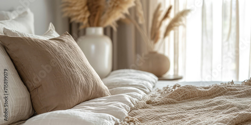 Boho Style Bedroom with Natural white brown colors. Close-up of a cozy bedroom with boho chic decor, featuring earth-toned pillows and a macramé throw. photo