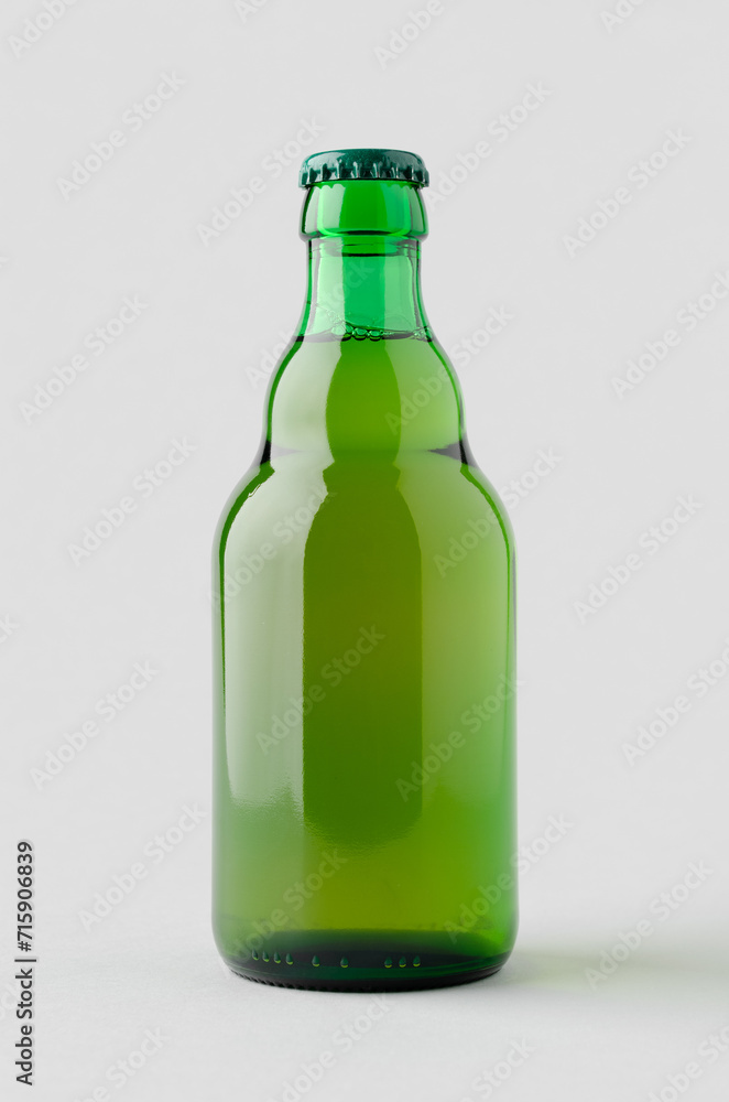 Green steinie beer bottle mockup on a grey background. Green steinie beer bottle mockup on a grey background.