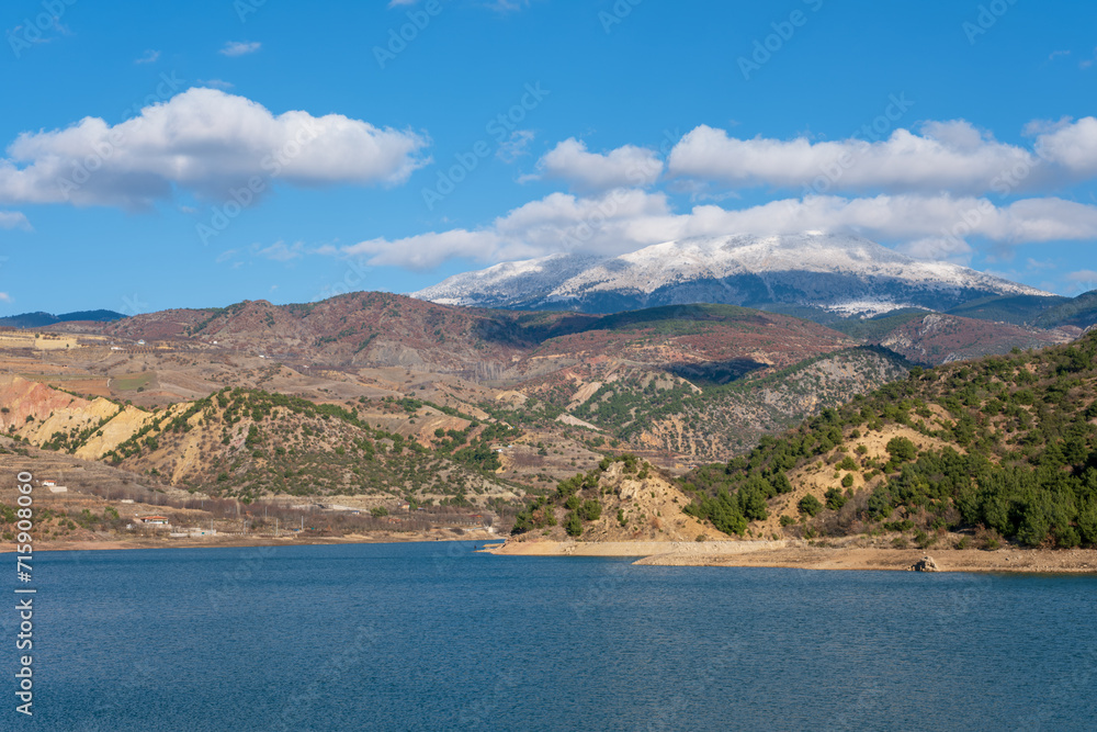 lake and mountains with white clouds