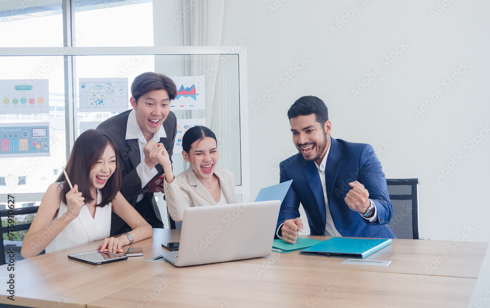 Portrait business team woman and man Asian group meeting sitting on desk looking computer hand holding laptop notebook ready for idea new project happy working online sale inside the home office Portrait business team woman and man Asian group meeting sitting on desk looking computer hand holding laptop notebook ready for idea new project happy working online sale inside the home office
